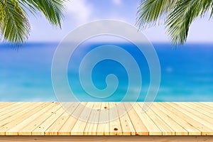 Wooden desk or plank on sand beach in summer. background.