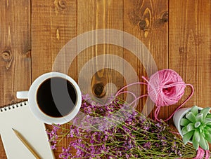 Wooden desk with stationery and coffee