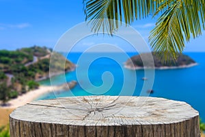 Wooden desk or stump on sand beach in summer. background.