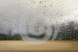 Wooden desk or wooden floor on water drop of the rain background vintage tone process.use for present or mock up your product.