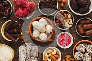 Wooden desktop with assortment of healthy sweets and nuts