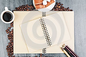Wooden desktop with notepad and coffee