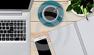 Wooden desktop with objects needed for work. Modern laptop, smartphone, cup of coffee and notepad with blank sheets laying at wood