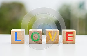 The wooden dice that line up form the word \'love\'.