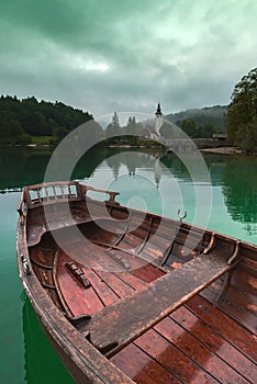 Wooden dinghy rowboat on lake