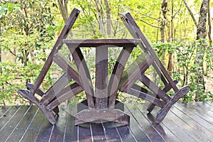 Wooden dining table set in lush garden setting