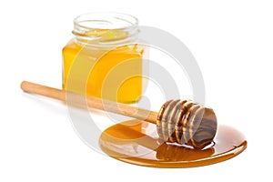 Wooden dipper with honey and bottle isolated