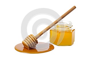 Wooden dipper with honey and bottle isolated