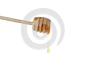 Wooden dipper with honey isolated on white