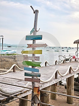 Wooden direction sign at the beach