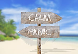 Wooden direction sign with calm and panic