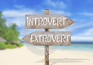 Wooden direction sign with introvert and extrovert