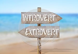 Wooden direction sign with introvert and extrovert