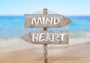 Wooden direction sign with mind and heart