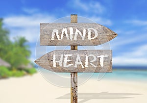 Wooden direction sign with mind and heart