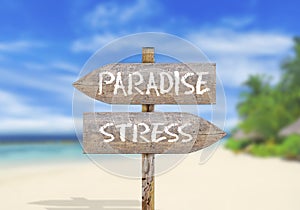 Wooden direction sign paradise or stress