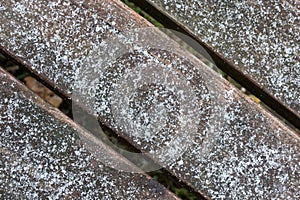 Wooden direction sign with snow on it and snowfall. two arrows in one direction .