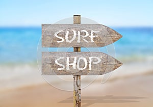 Wooden direction sign with surf shop