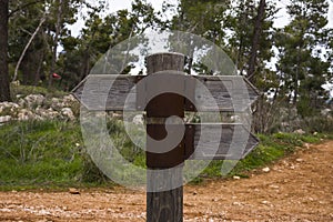 Wooden direction sign with two arrows in opposite directions on white background