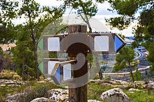 Wooden direction sign with two arrows in opposite directions on white background