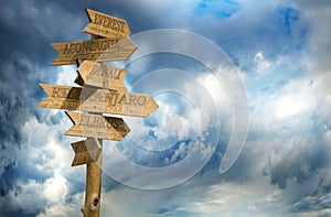 wooden direction signs mountains