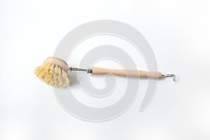 Wooden dish brush with bamboo wood and natural Bristle Tampico Fiber, on white background . Item for cleaning in kitchen