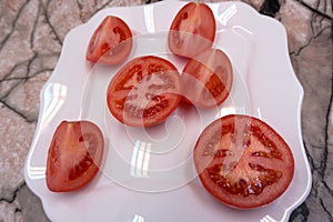 Wooden dish with cherry tomatoes on grey background . photo