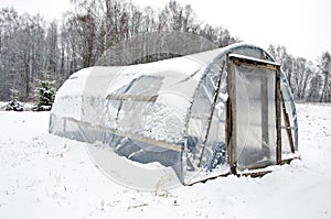 Wooden diy homemade greenhouse polythene snow photo