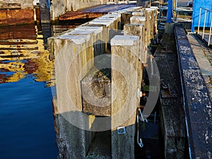 Wooden dock breakwall in a marina harbor photo