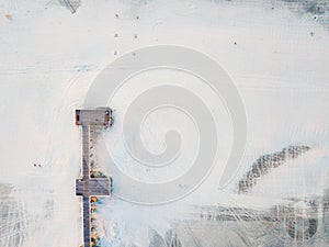 Wooden dock on a empty beach aerial view