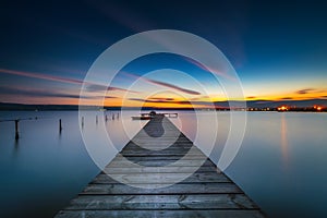 Wooden Dock and fishing boat at the lake, sunset shot