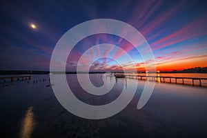 Wooden Dock and fishing boat at the lake, sunset shot