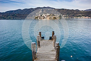Wooden dock on Lake Orta, opposite the island of San Giulio isla