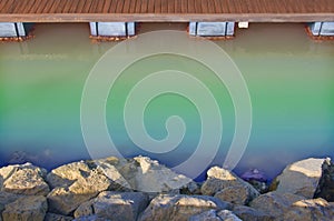 Wooden dock, rainbow river and sandy rocks