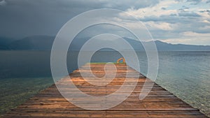 Wooden dock in Tsolis beach before the storm in Achaea, Greece