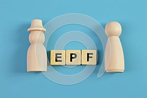 Wooden doll figures and alphabet letters with text EPF stands for Employees Provident Fund