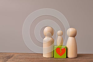 Wooden doll figures of family with break love heart. Concept of divorce