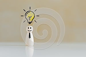 Wooden doll people human women standing with light bulb icon idea, intelligent think power.