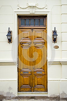 Wooden door and antique luminaires photo