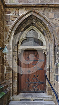 Wooden door with archway and steps