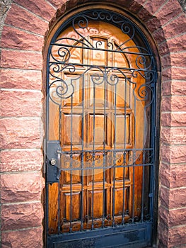 Wooden Door with black iron gate