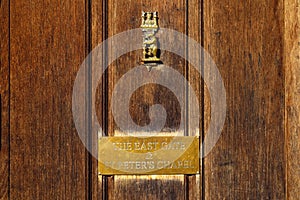 Wooden door with brass knocker warwickshire england