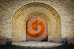 Wooden door on brick wall church in Copenhagen