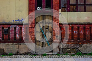 The wooden door of dilapidated building in a city