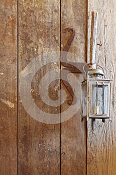 Wooden door made of barn wood with rustic vintage candle lamps