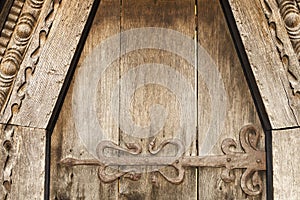 Wooden door with metal decoration