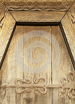 Wooden door with metal decoration