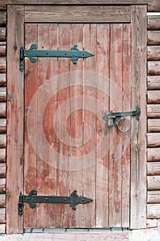 Wooden door with metal hinges.