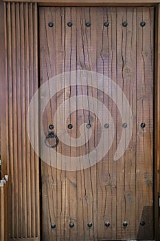 Wooden Door With Metal Rivets And Metal Door Knock
