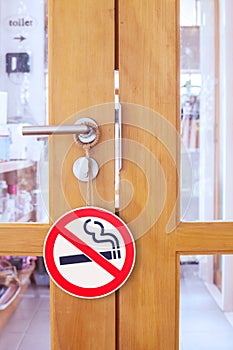 Wooden door with no smoking sign in cafe shop